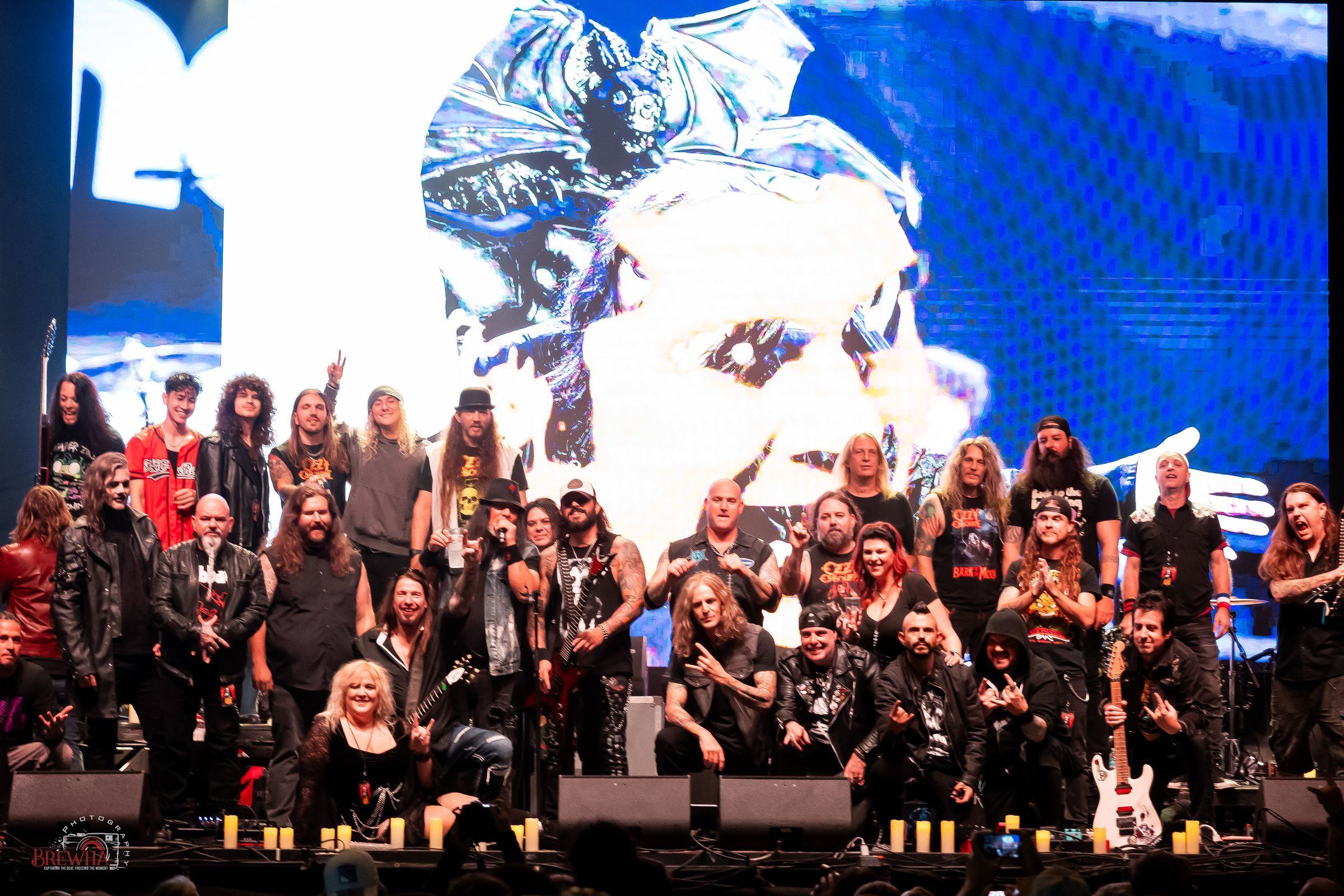 The whole cast on stage together, with Ozzy on the screen behind them