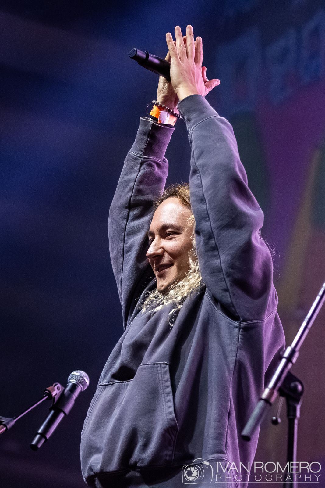 A singer reaching up