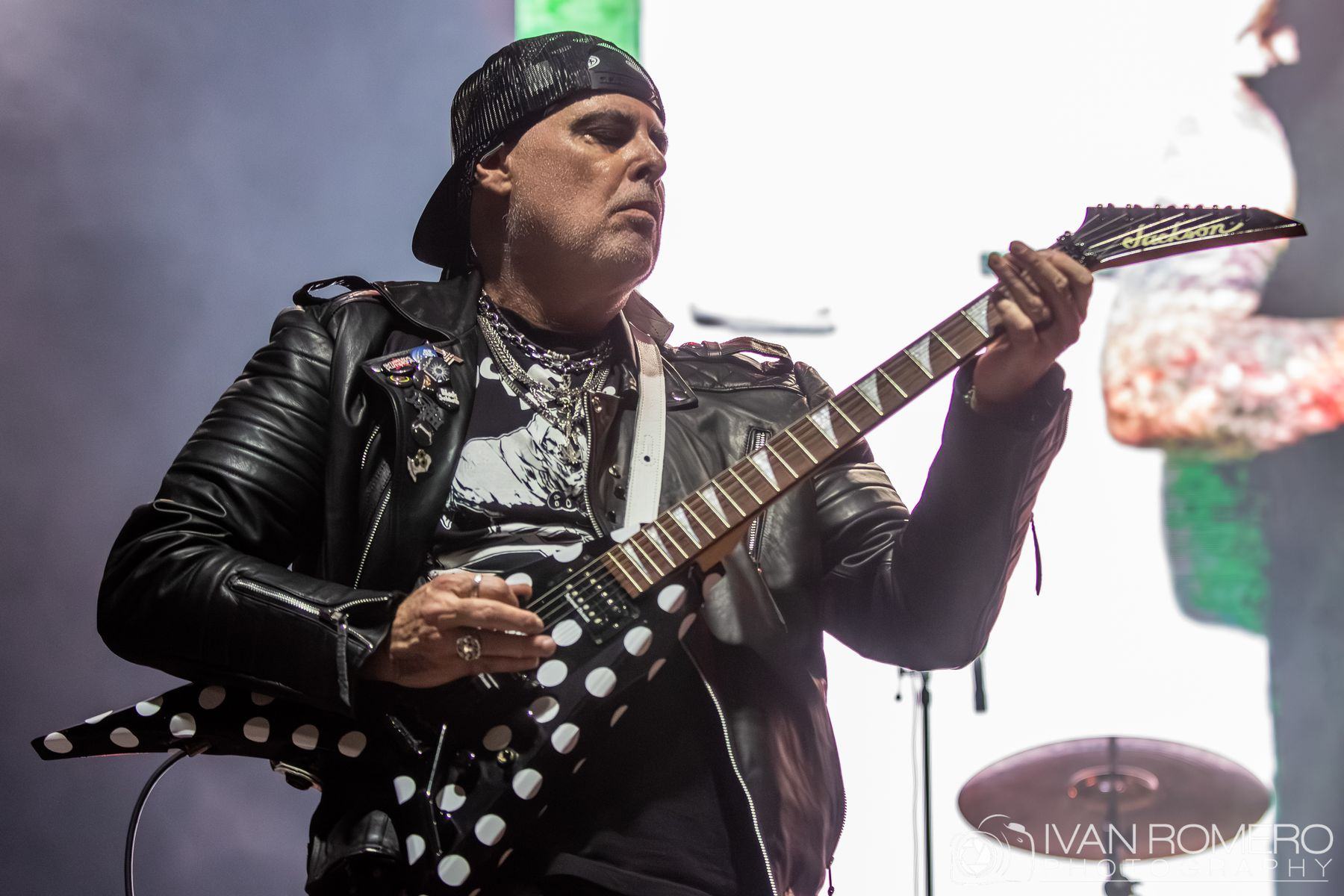 A guitarist on stage playing a polka-dot V