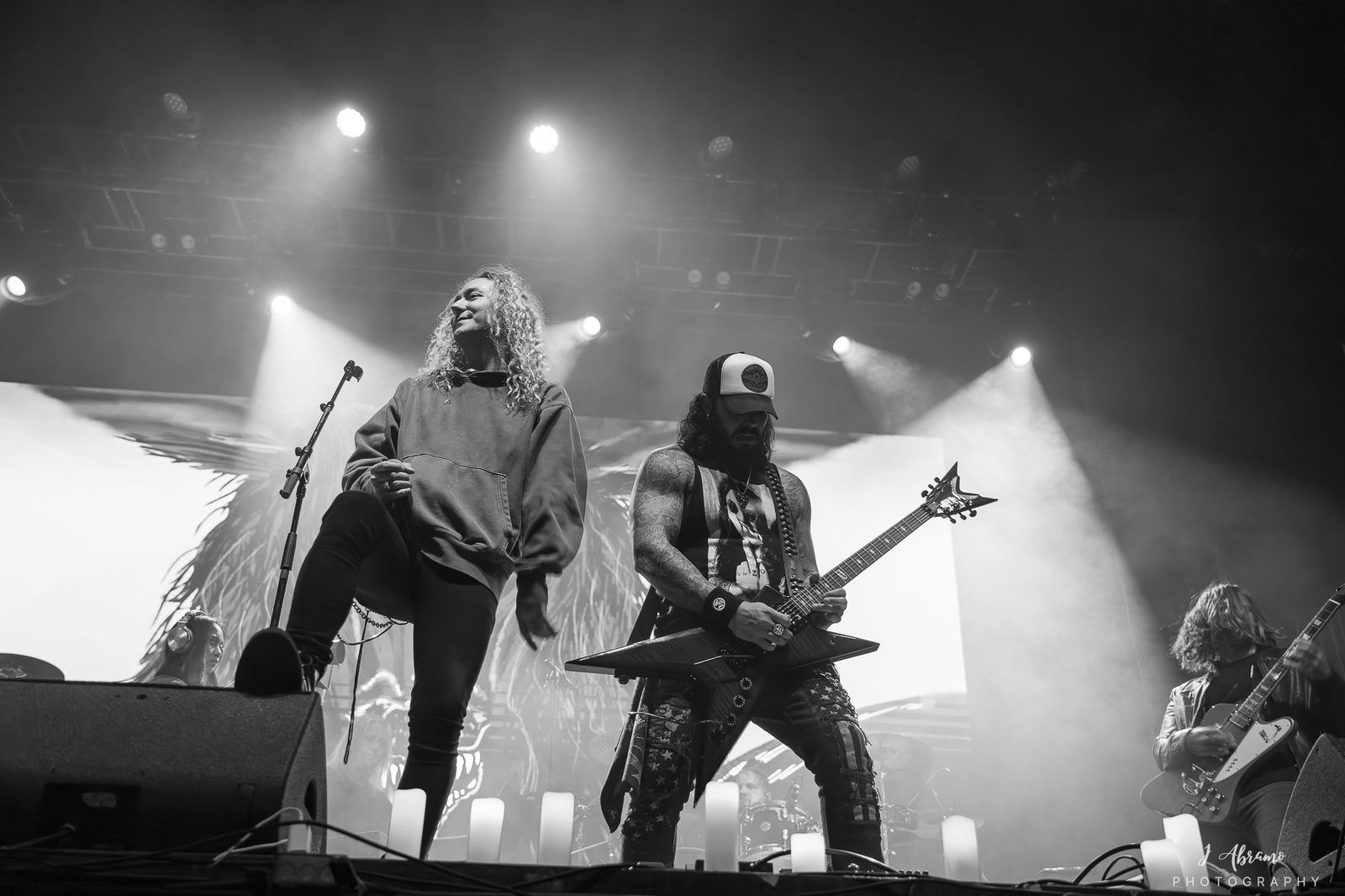 Black and white: guitarists under white stage light