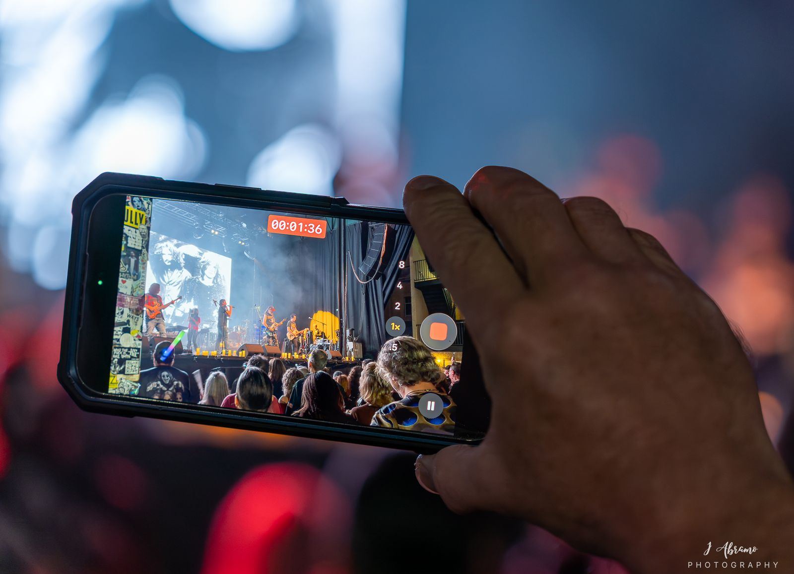 A phone in the crowd filming the stage