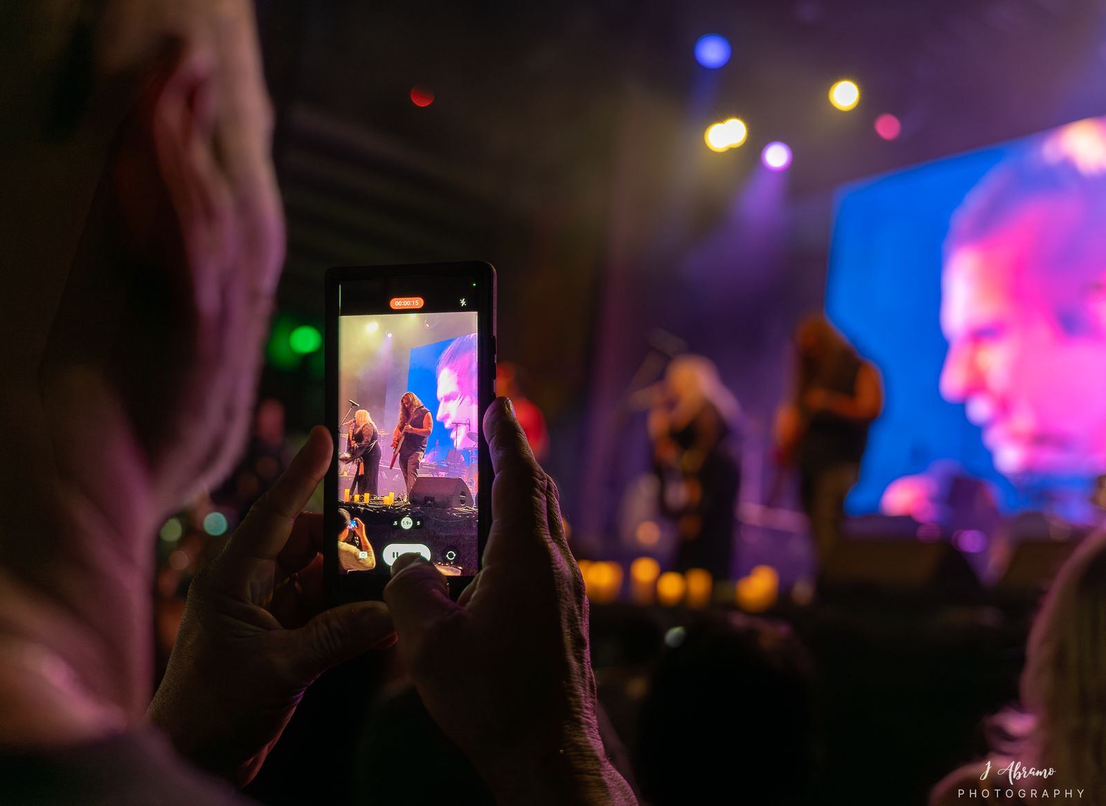 A phone held up toward the stage