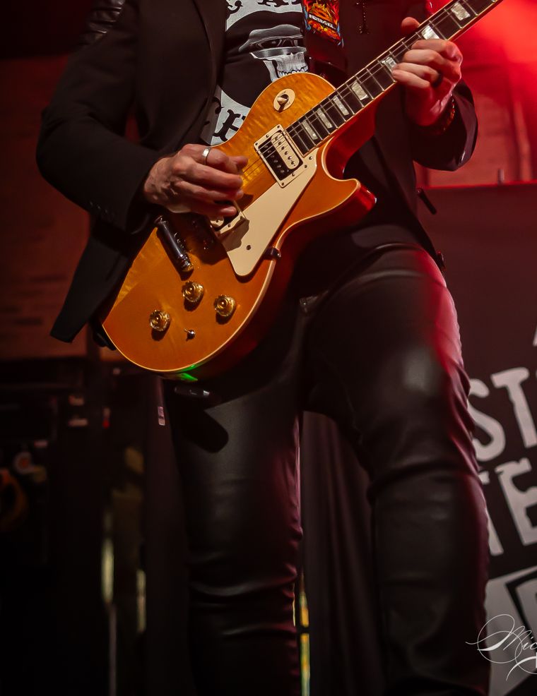 Detail: a gold-top guitar against black leather. Photo: Michael Key Photography.
