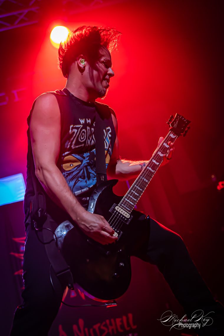 Guitarist mid-riff, lit red. Photo: Michael Key Photography.