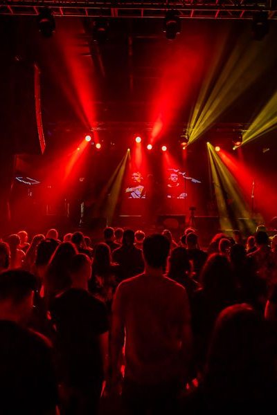 The room from the stage: red and amber beams over the crowd. Photo: Michael Key Photography.