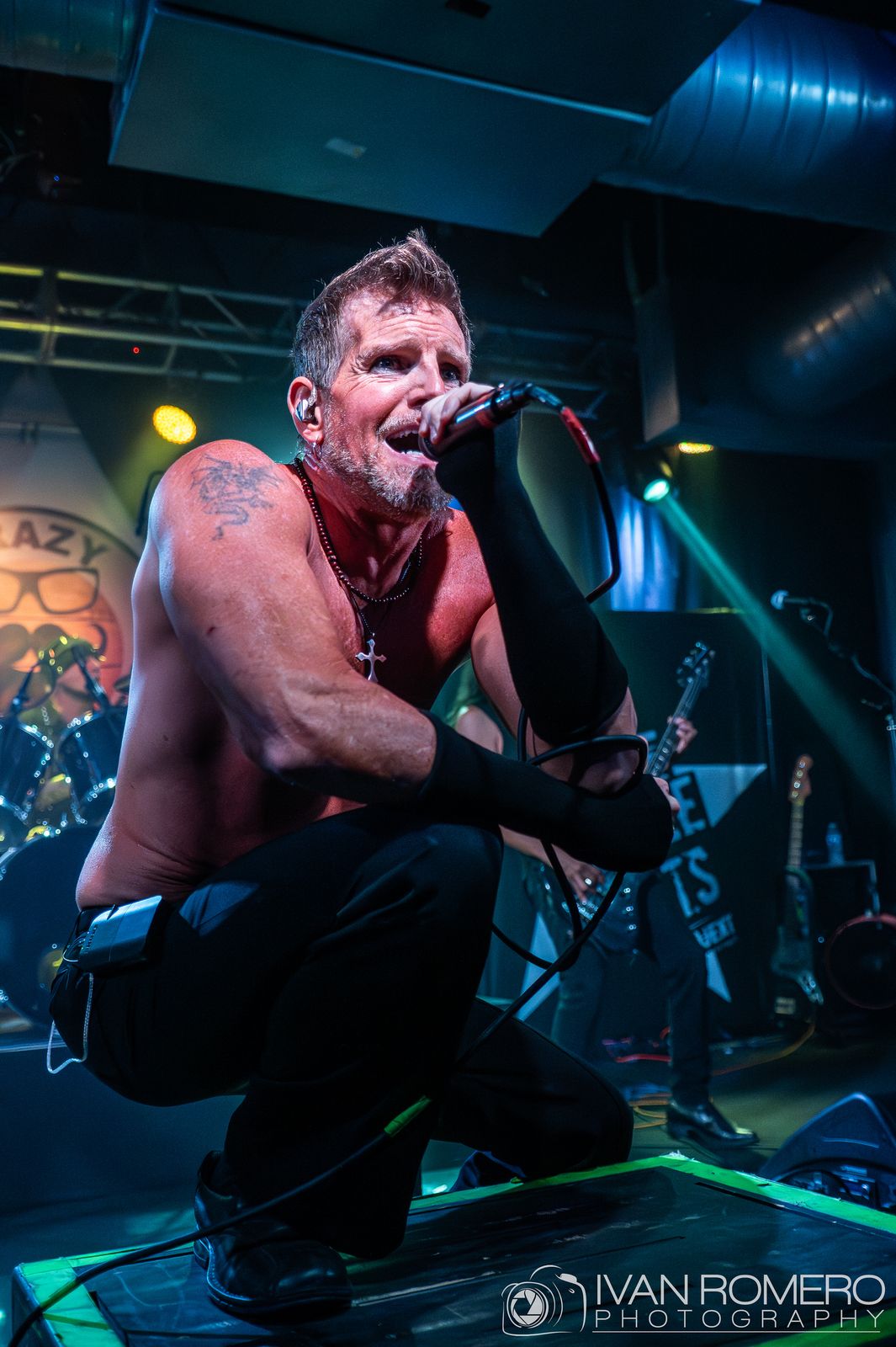 The singer crouched at the lip of the stage
