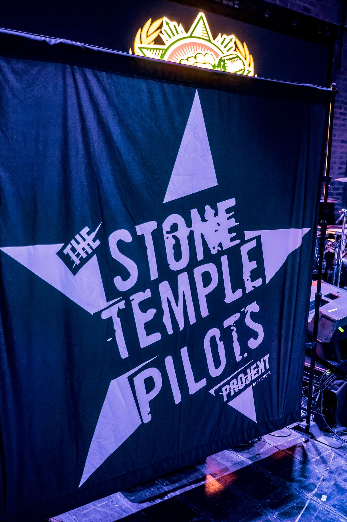 The star-logo banner hanging on stage at Revolution Live