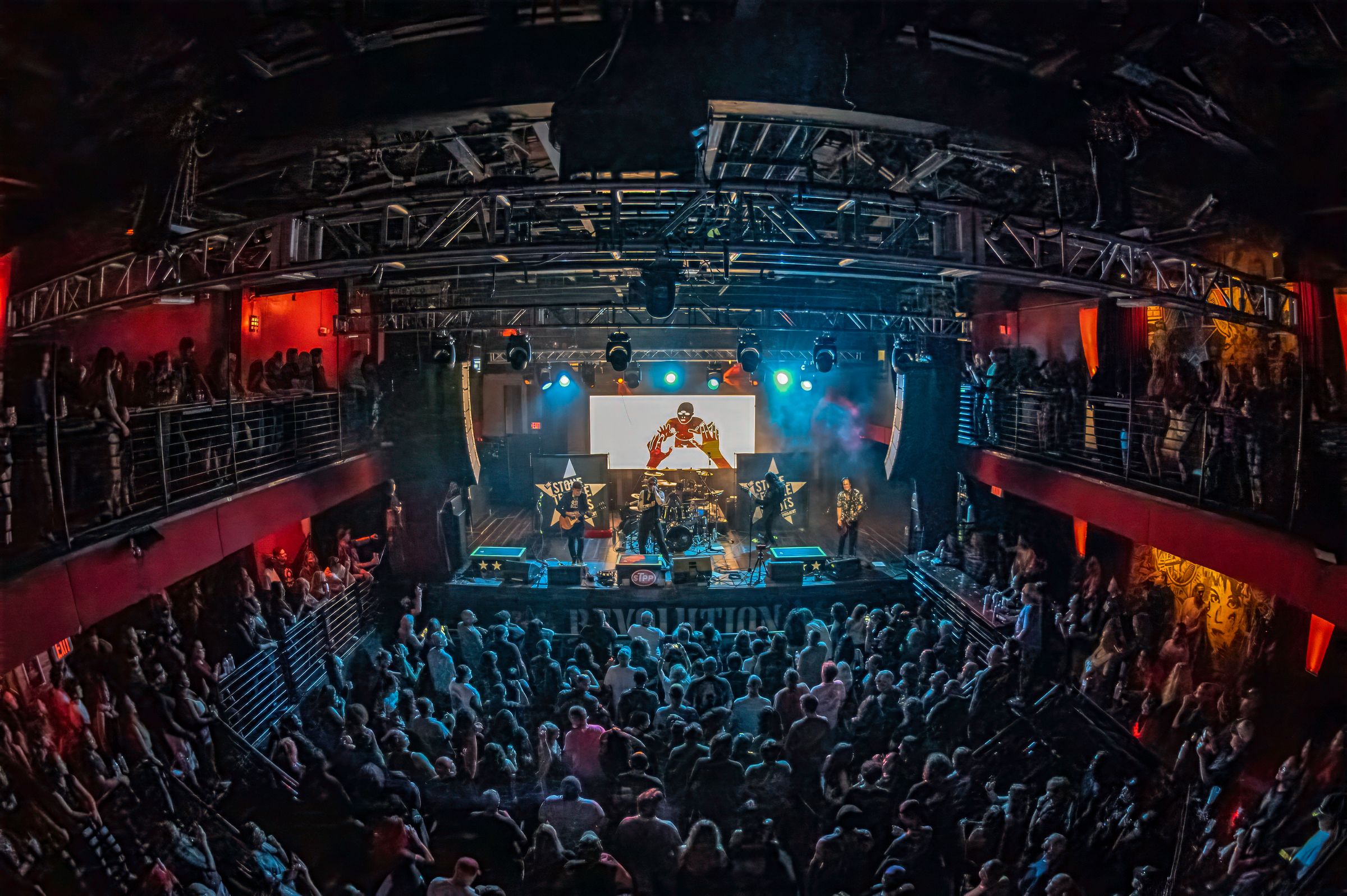 A packed Revolution Live seen from the balcony, the band lit on stage