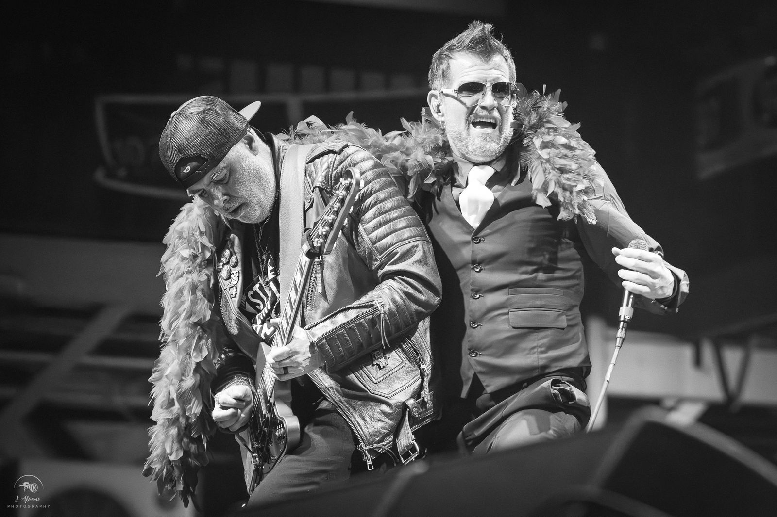 Black-and-white: the singer and guitarist leaning together, laughing