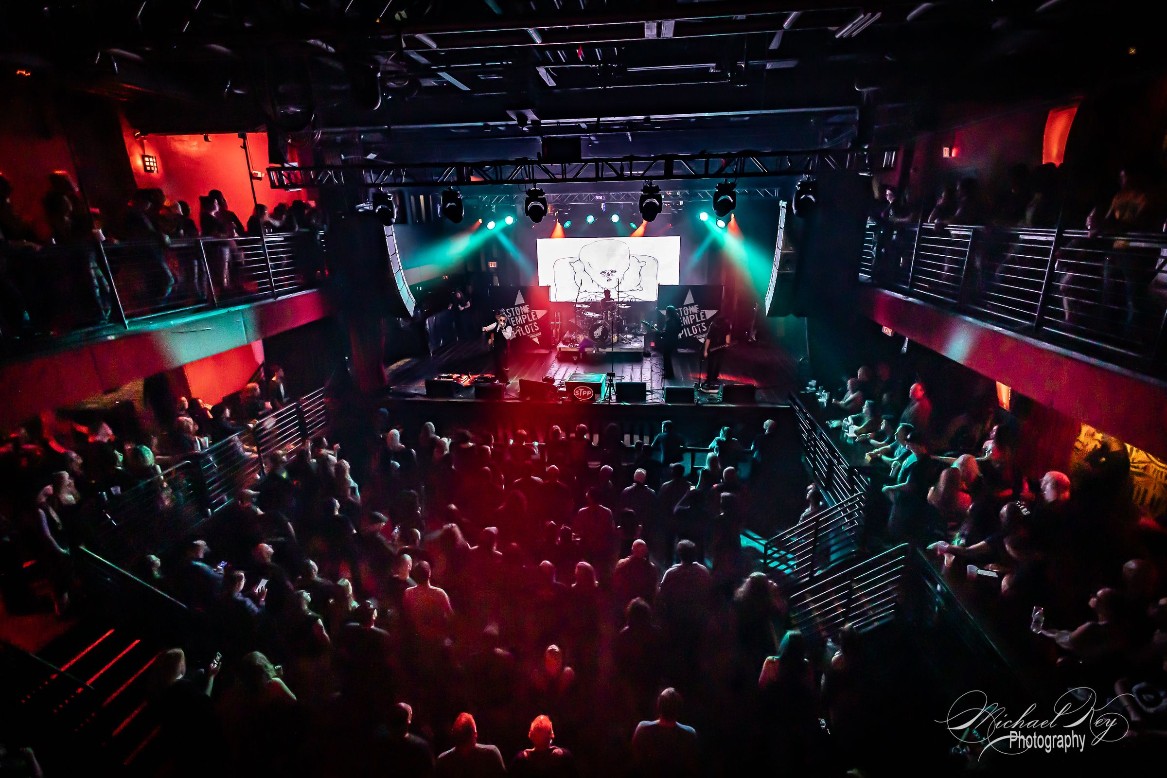 The crowd at Revolution Live under purple and gold lights, seen from the stage
